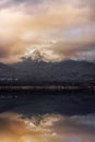 Sunset on the lake with the reflection of mountains Royalty Free Stock Photo