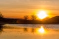 Sunset, on the lake, reflection, water and the rays of the sun. Royalty Free Stock Photo