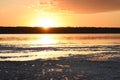 Sunset on the lake. The sun setting over the horizon Royalty Free Stock Photo