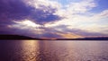 Sunset on the lake before a thunderstorm. Dramatic sky. Reflection of sunlight in water. Ripples. Royalty Free Stock Photo