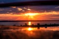 Sunset on the lake. View of the setting sun from the car window. Royalty Free Stock Photo
