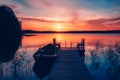 Sunset on a lake. Wooden pier with fishing boat at sunset in Finland Royalty Free Stock Photo