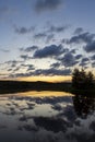 Beautiful sunset at the lakeside in Finland with glowing sky.