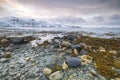 Sunset at the lakeside with rocks of a fjord during low tide in