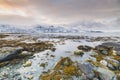 Sunset at the lakeside with rocks of a fjord during low tide in