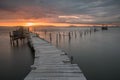 Sunset landscape of artisanal fishing boats in the old wooden pier. Carrasqueira is a tourist destination for visitors to the coas Royalty Free Stock Photo