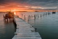 Sunset landscape of artisanal fishing boats in the old wooden pier. Royalty Free Stock Photo