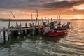 Sunset landscape of artisanal fishing boats in the old wooden pier Royalty Free Stock Photo