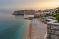 Sunset landscape with Banje beach and old town of Dubrovnik, Dalmatia, Croatia. Medieval fortress on the sea coast Royalty Free Stock Photo