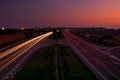 Sunset landscape with car lights on highway overtaking long exposure Royalty Free Stock Photo