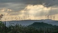 Sunset Landscape on a Cloudy Day With a View of a Wind Farm on a Hill Royalty Free Stock Photo