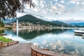 Sunset landscape of Lavena Ponte Tresa with fountain and reflections in the lake of Lugano-Ceresio.. Royalty Free Stock Photo