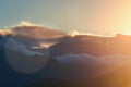 Sunset landscape with lens flare, mountains and clouds as an background Royalty Free Stock Photo