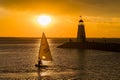 Sunset landscape with man sailing a boat around Lake Hefner Royalty Free Stock Photo
