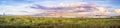 Panoramic sunset landscape of the marshes of south San Francisco bay, Mission Peak covered in sunset colored clouds