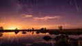 sunset landscape with meteor shower in action. Starry sky with lake and bushes at summer. Beautiful Universe