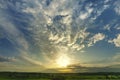 Sunset landscape with sky and clouds, green grass spring. Wide. Royalty Free Stock Photo