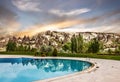 Rock mountain sunset landscape with swimming pool, Capaddocia, Goreme, Turkey Royalty Free Stock Photo