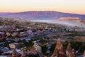 Sunset landscape view of ancient Goreme in Cappadocia. Amazing cave houses in shaped sandstone rocks