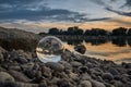 Sunset through lensball at water edge