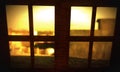 Sunset light through dirty stable window Royalty Free Stock Photo