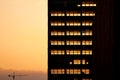 Sunset light going through skeleton of dismantled building. Deconstruction of old office skyscraper.