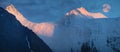 Sunset light in the mountains, full moon over the peaks. Panorama, Belukha Mountain, Altai