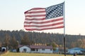 Sunset light passes through a waving U.S. flag near Terrebonne