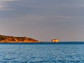 Sunset Light on Promontory and Rocky Islet, Greece