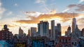 Sunset light shines behind the buildings of the lower Manhattan skyline in New York City