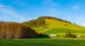 Sunset lights idyllic farm scene of beautiful green fields and hills