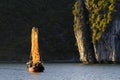 Sunset lights on a junk and the rock