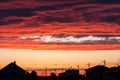 Sunset lights up the clouds above an urban street Royalty Free Stock Photo