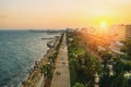 Sunset in Limassol, Cyprus. Mediterranean resort. Aerial panoramic view of Limassol city promenade with wooden piers in