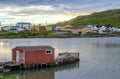 Sunset at little red dock house in village community of Twillingate, Newfoundland. Royalty Free Stock Photo