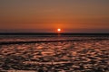 Sunset at low tide on the Nordstrand peninsula with a view of the Halligen