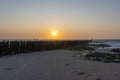 Sunset during low tide at the pile heads of Westkapelle, Netherlands