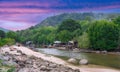 sunset and lush mountains in a fishing village Patong phuket thailand Long-tail boats and fishing timber huts long tail boats