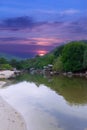 sunset and lush mountains in a fishing village Patong phuket thailand Long-tail boats and fishing timber huts long tail boats