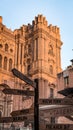 Sunset in Malaga's cathedral with vivid colors and a sign telling us the distance to different places around the world Royalty Free Stock Photo