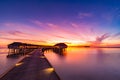 Sunset on Maldives island, luxury water villas resort and wooden pier. Beautiful sky and clouds and beach background for summer va Royalty Free Stock Photo