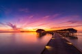 Sunset on Maldives island, luxury water villas resort and wooden pier. Beautiful sky and clouds and beach background for summer va Royalty Free Stock Photo