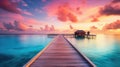 Sunset on Maldives island, luxury water villas resort and wooden pier. Beautiful sky and clouds and beach background for summer Royalty Free Stock Photo