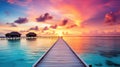 Sunset on Maldives island, luxury water villas resort and wooden pier. Beautiful sky and clouds and beach background for summer Royalty Free Stock Photo