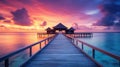 Sunset on Maldives island, luxury water villas resort and wooden pier. Beautiful sky and clouds and beach background for summer Royalty Free Stock Photo