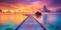 Sunset on Maldives island, luxury water villas resort and wooden pier. Beautiful sky and clouds and beach background for summer Royalty Free Stock Photo