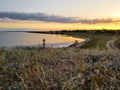 Sunset in the meadow near the estuary in early autumn. Royalty Free Stock Photo