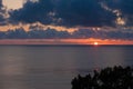 Sunset at Mediterranean sea. Orange cloudy sky at sundown. Mediterranean sea at nightfall. Beautiful ocean at orange