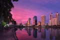 Sunset, modern highrises reflecting in lake by park. Bangkok, Thailand. Beautiful landscape, residential area. Royalty Free Stock Photo