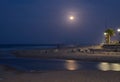 Sunset with the moon in the background reflected in the sea on the beach of Gandia, Valencia. Spain. Royalty Free Stock Photo